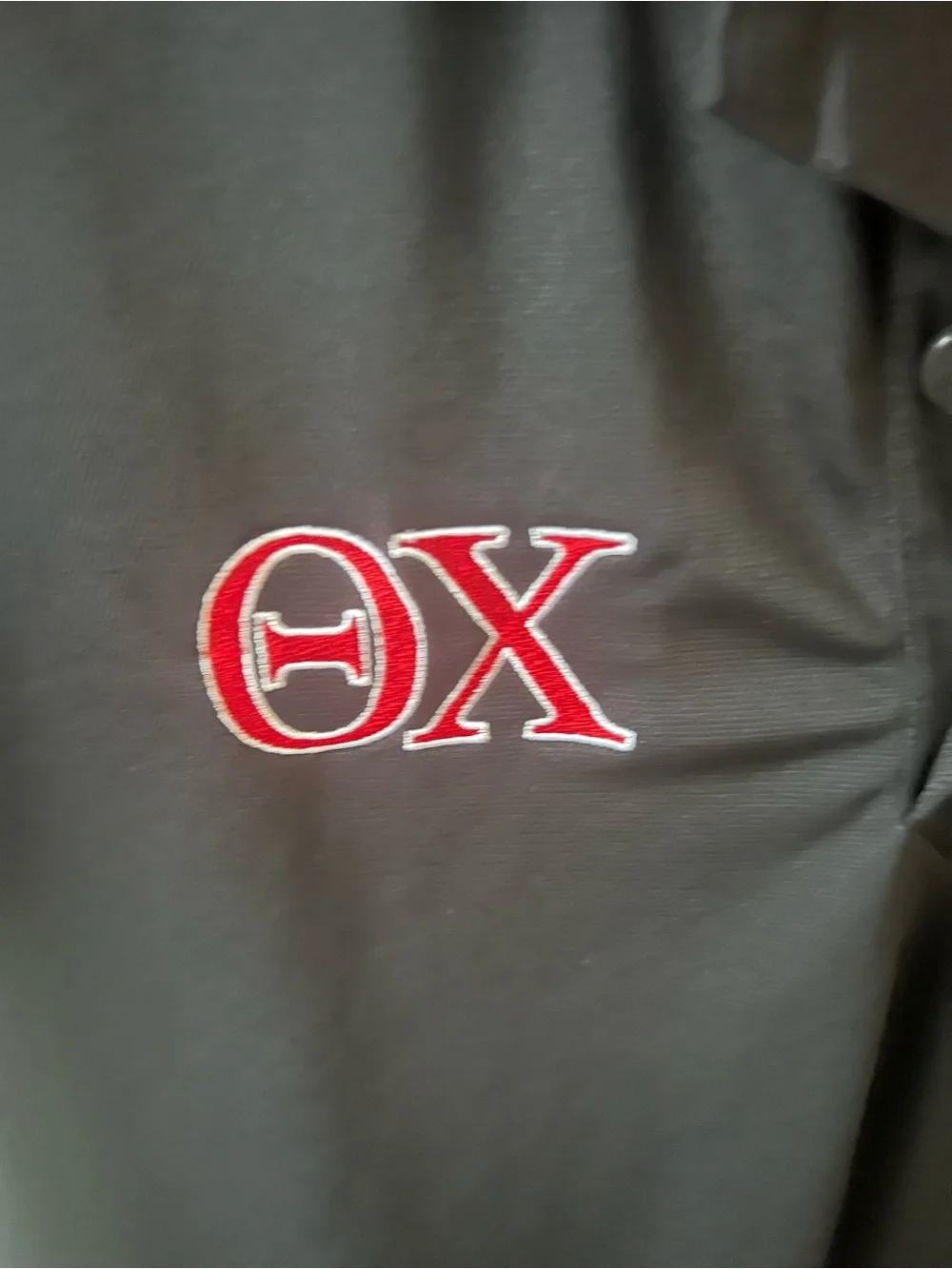 Jordan Black Men's Polo Shirt with Theta Chi Fraternity logo embroidered